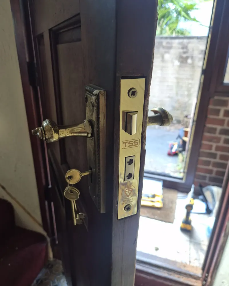 Mortice lock with brass handles repaired on a timber door